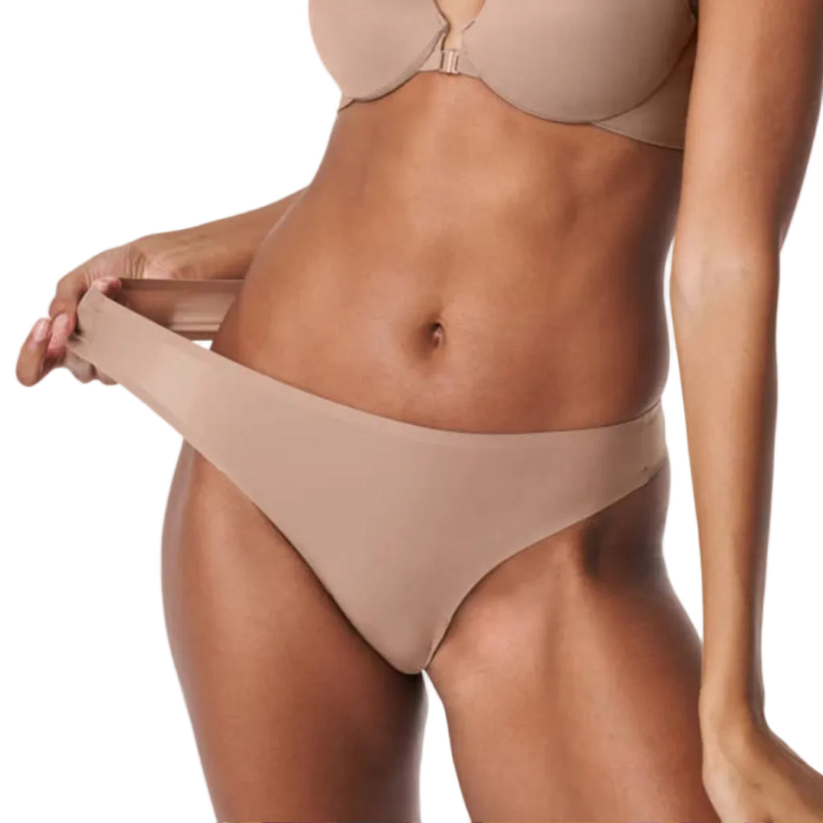 Woman wearing a beige bikini on a white background
