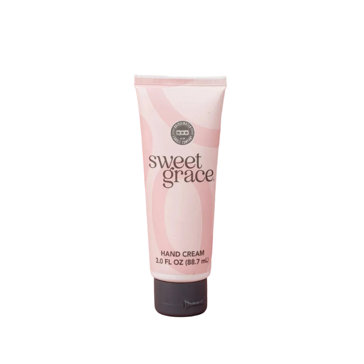 Tube of Sweet Grace hand cream on a pink background