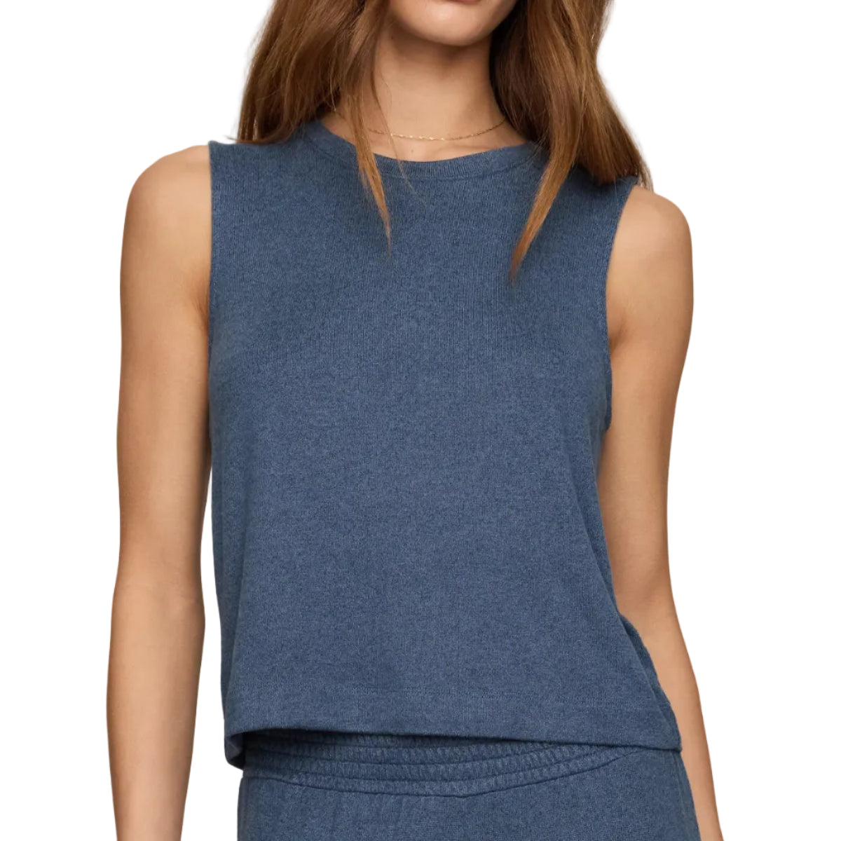 A woman modeling a sleeveless heathered blue knit top and matching blue pants