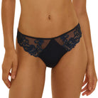 Navy blue lace lingerie set on a beige background