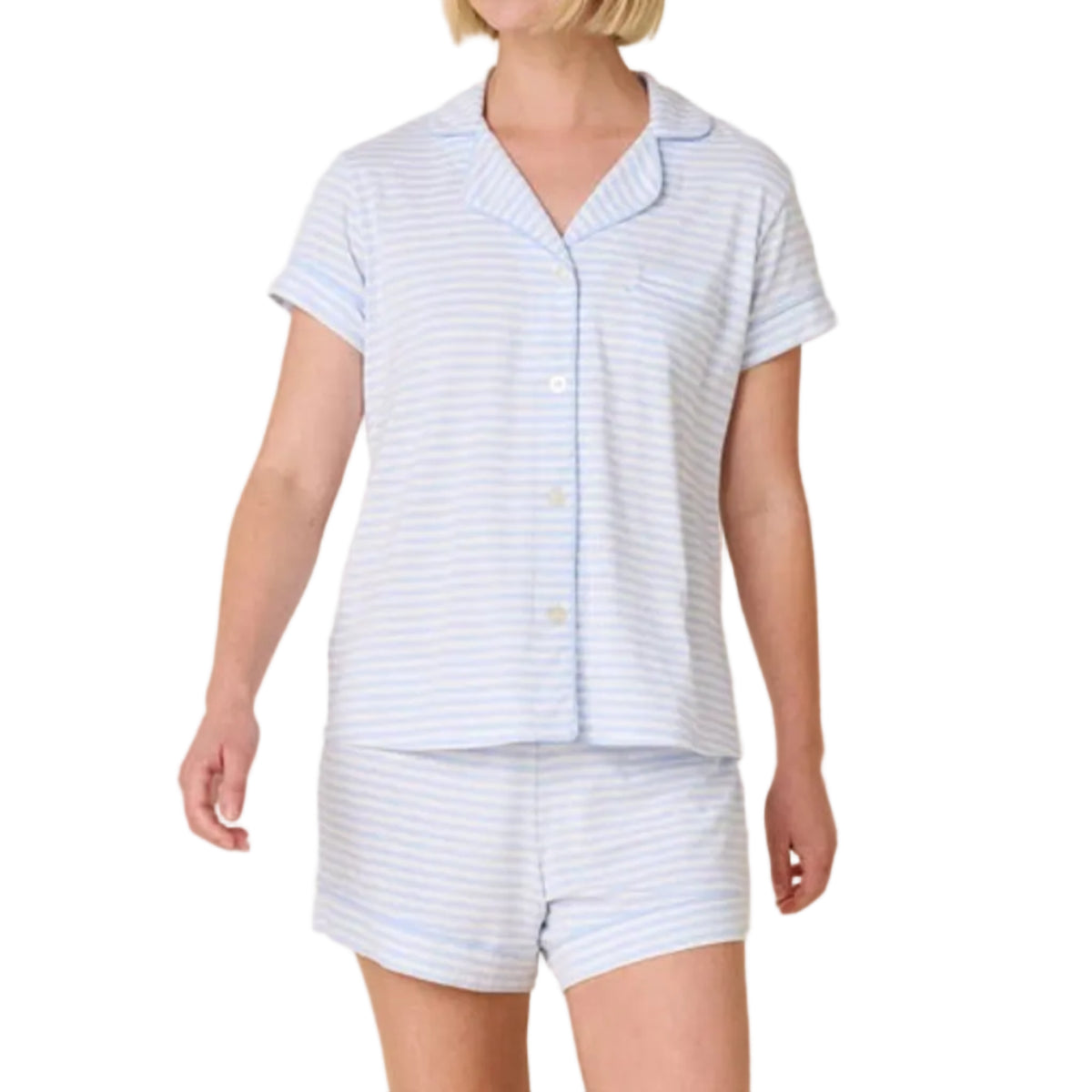 Woman wearing a light blue striped pajama set on a white background