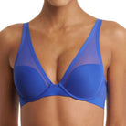 A close-up of a model wearing a royal blue mesh and molded-cup bra, showing the front view against a plain white background.
