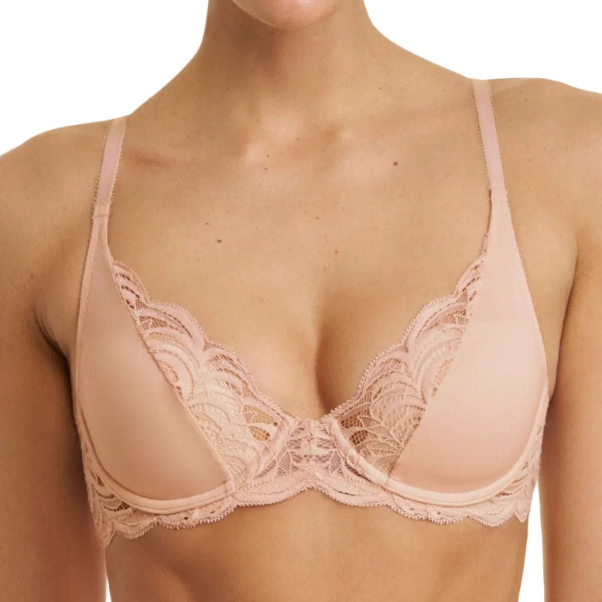 A close-up of a model wearing a light pink lace-trimmed bralette against a plain white background.