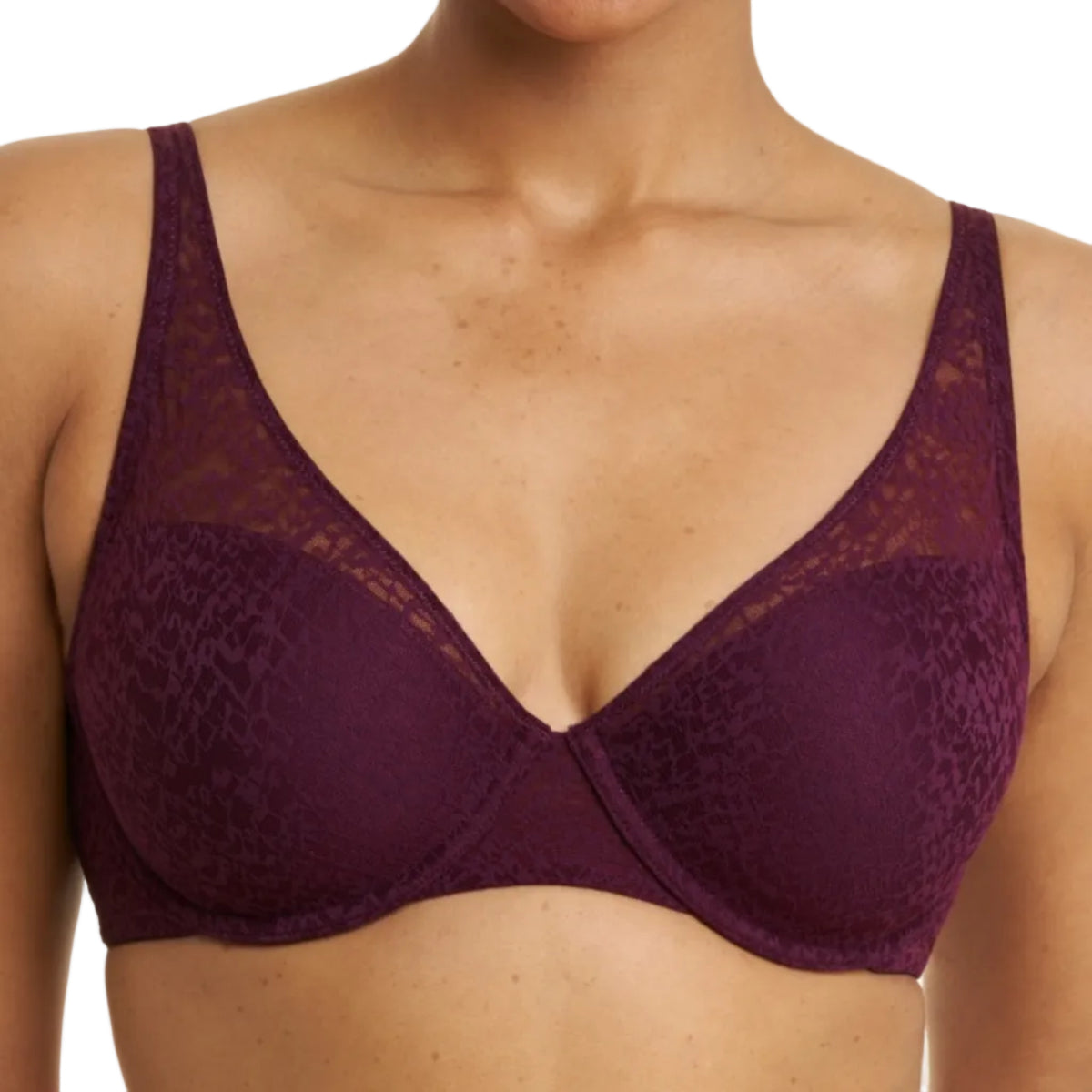 A close-up of a model wearing a deep plum purple lace bra with sheer mesh cups against a plain white background.