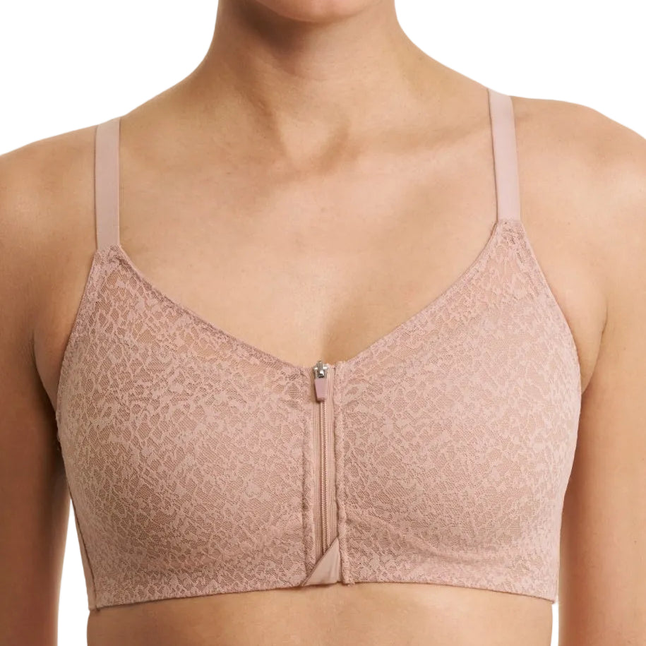 A close-up of a model wearing a light pink lace bralette with a front zipper closure, set against a plain white background.
