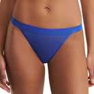 A close-up of a model wearing a bright royal blue bikini bottom against a plain white background.