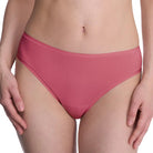Person wearing a pink bikini bottom on a white background