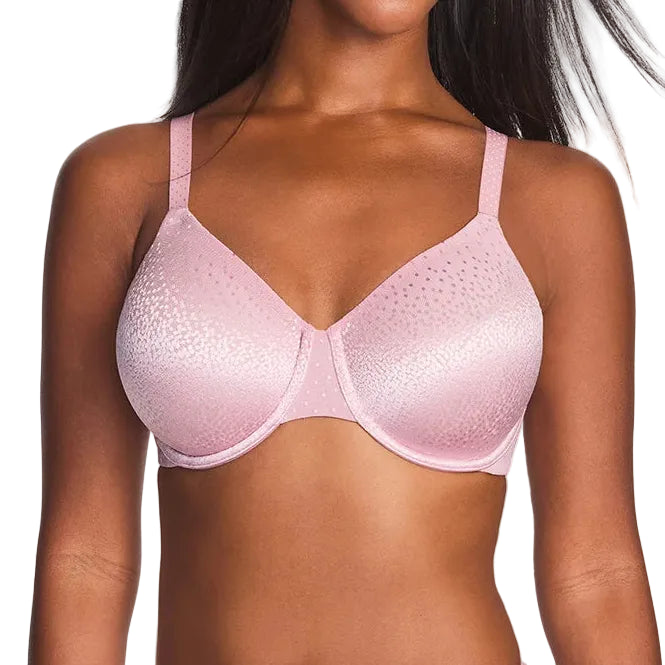 A woman modeling a light pink seamless underwire bra with a subtle textured pattern on the cups, set against a plain light gray background.