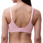 Pink bra worn by a person on a white background