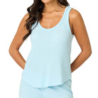Woman wearing a light blue pajama set on a white background