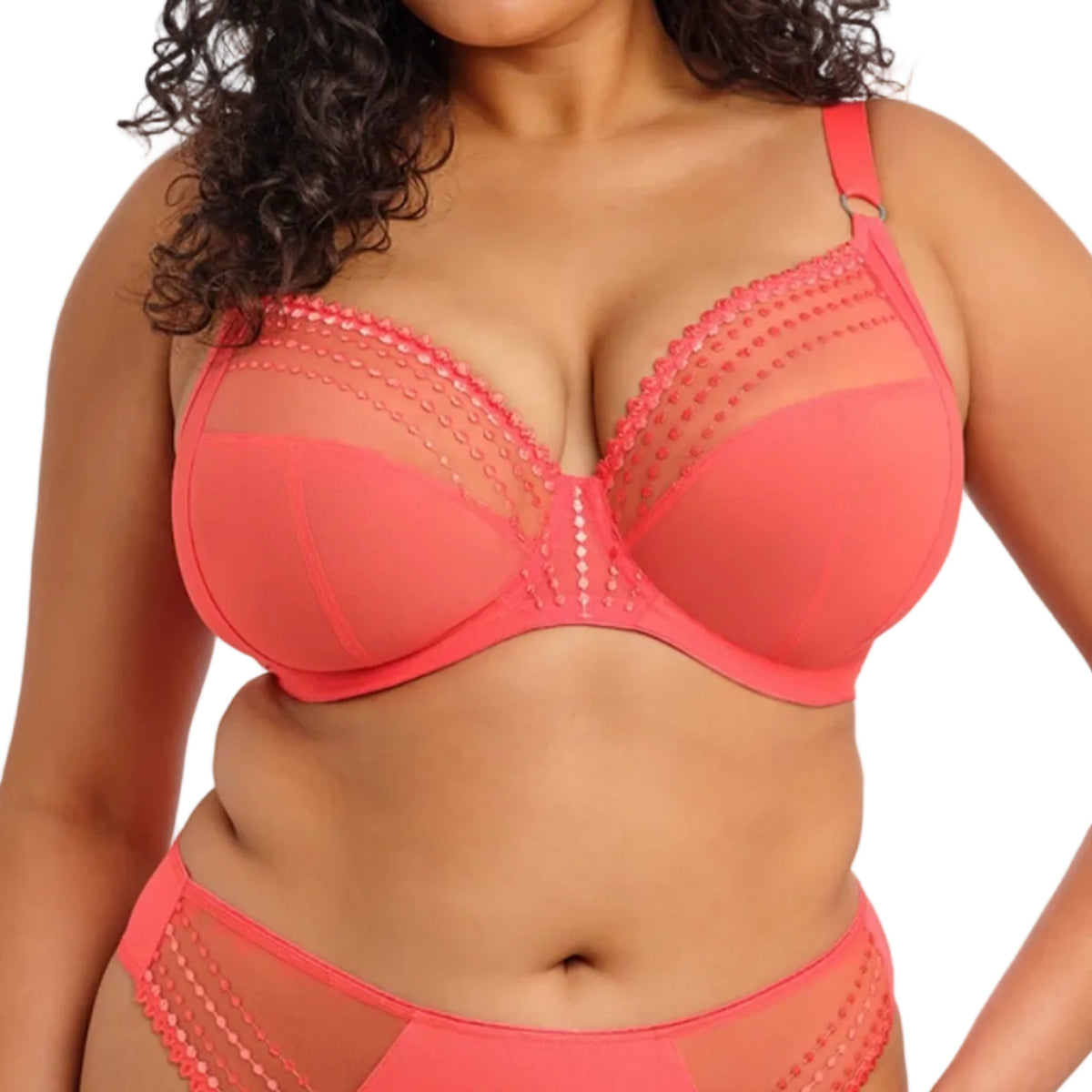 Woman wearing a coral bra on a white background