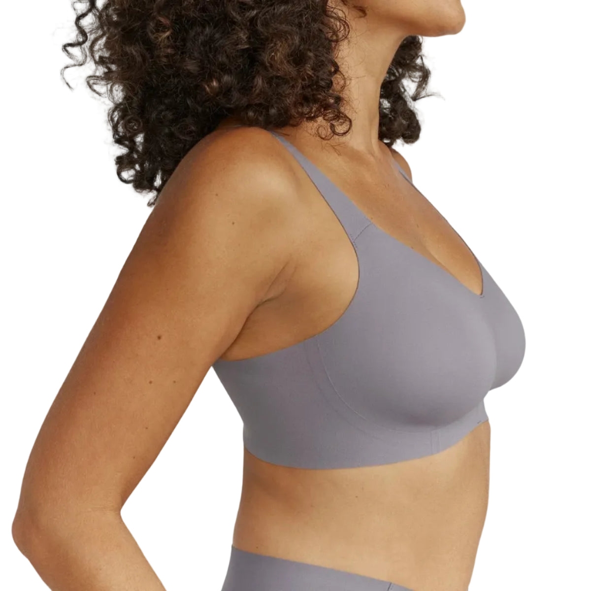 Woman wearing a gray sports bra on a white background