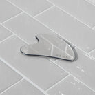 Metallic kitchen tool on a tiled surface with 'kit-sch' branding.