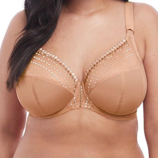 Sheer plunge underwire bra in café au lait beige is a lingerie drawer essential. Embroidered bead detail makes this basic shine! The low center front gives this plunge-style bra cleavage enhancement without added padding. The three-section cup with side panel gives forward shape, separation and excellent lift. Versatile moveable J-hook fastening allows the back to be converted easily and quickly to a racer-back bra style.  Front view shown.