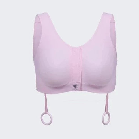 Pink post surgery bra. Recommended by surgeons following mastectomy with and without reconstruction, lumpectomy, cardio thoracic surgery. Soft performance fabric, velcro front, adjustable side openings and loops for surgery drain management.  Pocketed lining can hold a breast form or ice pack. Product view.